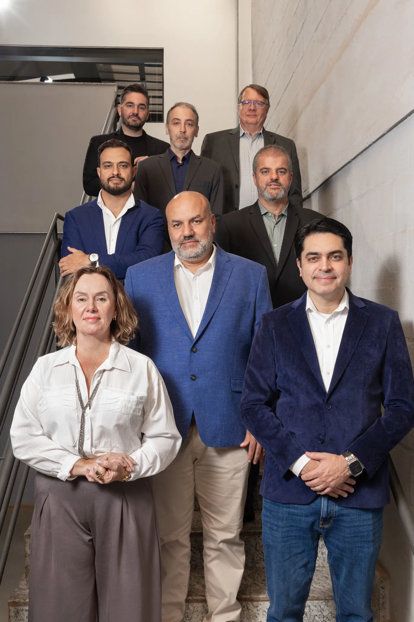 The Rysax leadership team, eight people, photographed together on a staircase.